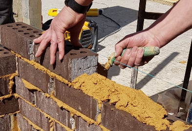 Bricklayer laying bricks during training