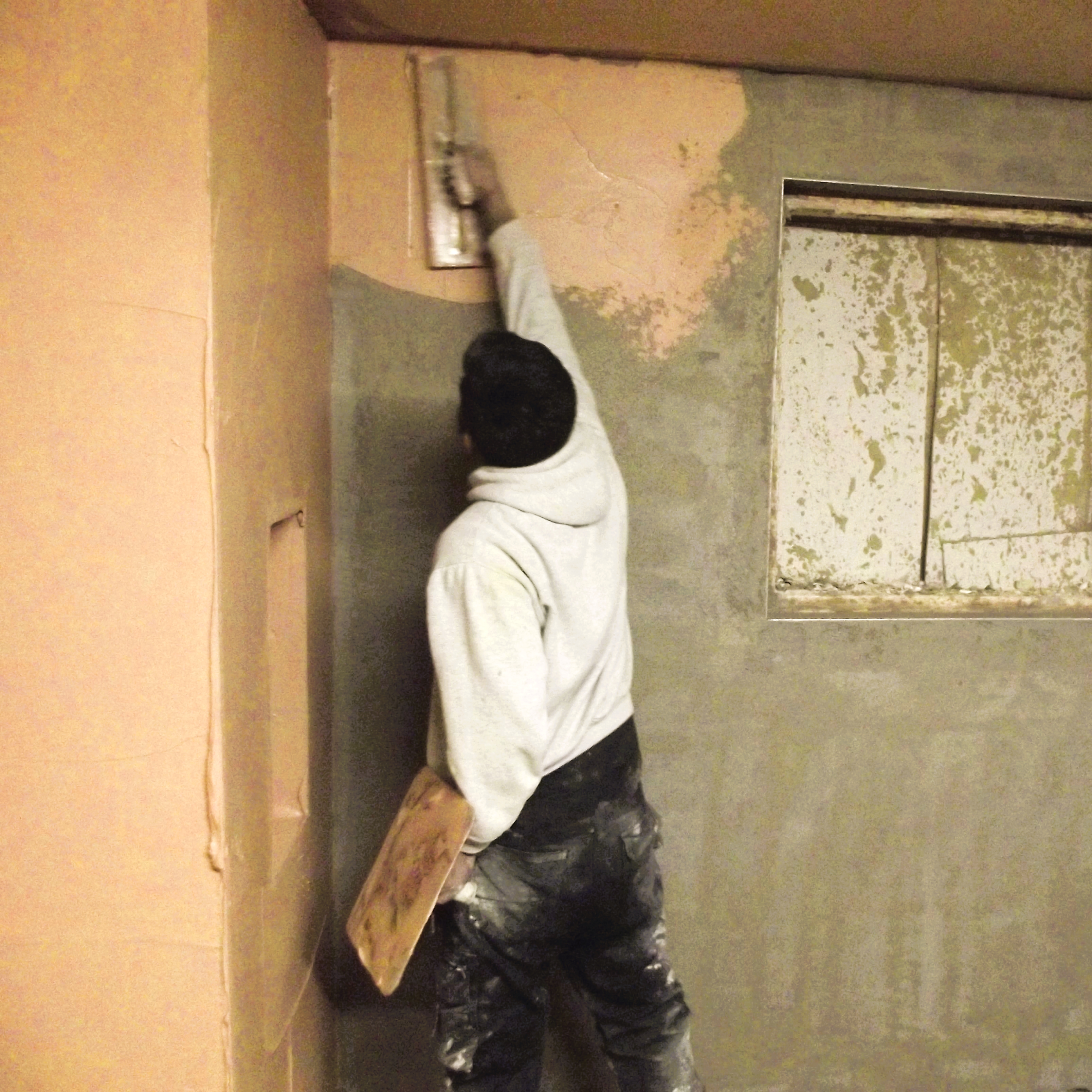 man plastering during his training course